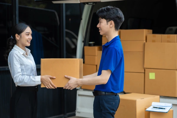 A courier man passing a package to a customer